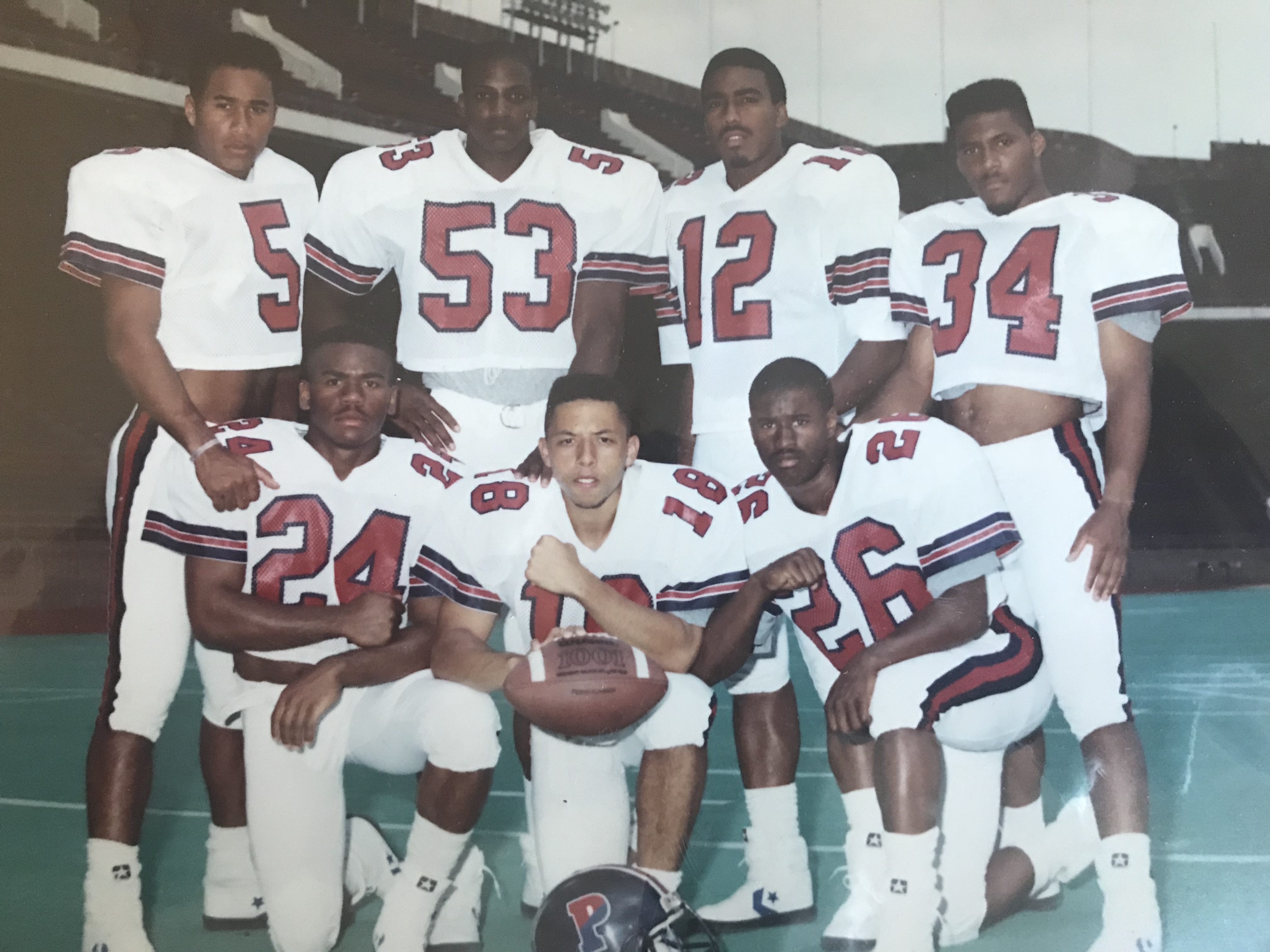 Mustafa Shabazz (number 53 back row second from the left) posting with 6 other teammates in their University of Pennsylvania football uniform