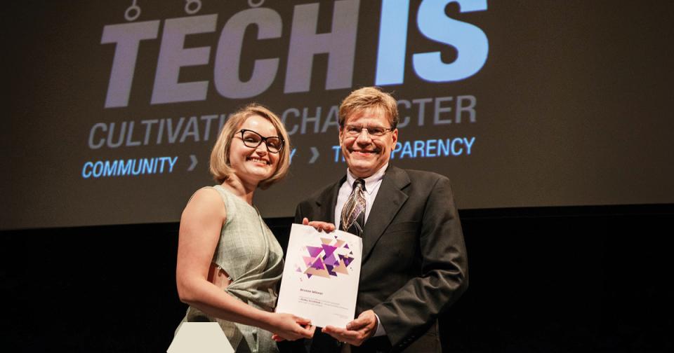 Bobby Strickland, senior graphic designer at Georgia Tech receiving his design award