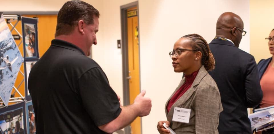 Veteran at career fair talking to potential employer