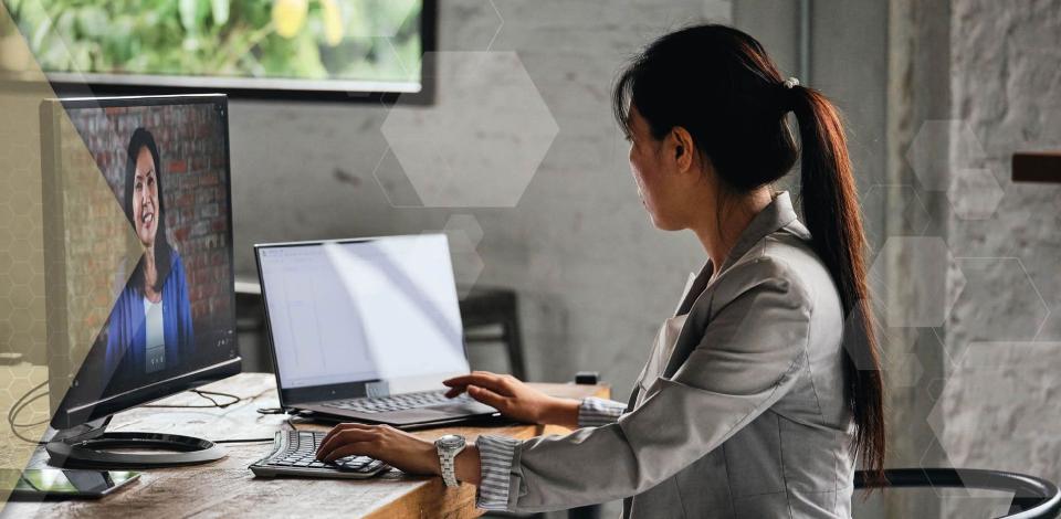 Female university student takes remote learning courses on laptop.