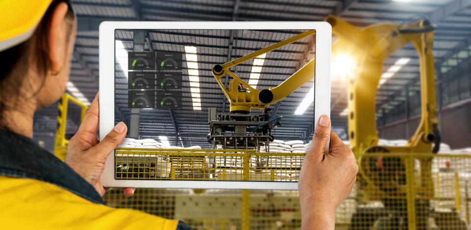 Woman taking picture of robotic arm using iPad