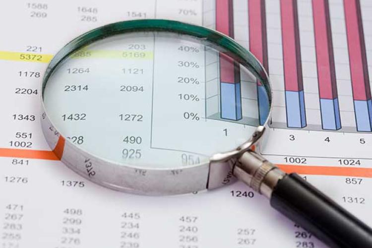 Magnifying class sitting on top of financial data