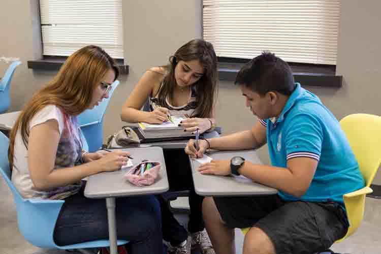 ESL students working at desks in a classroom