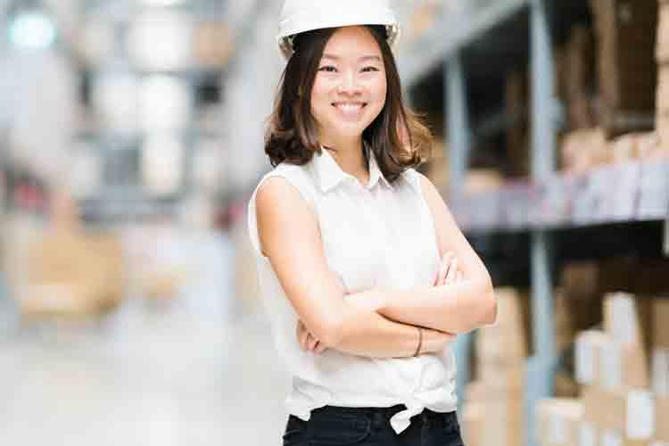 Logistics profession wearing hard hat in warehouse