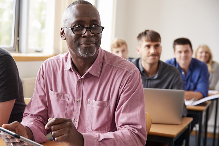 A man in a classroom learning