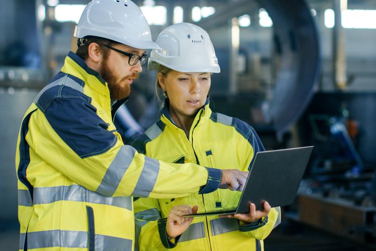 Occupational safety and health professionals collaborating on job site