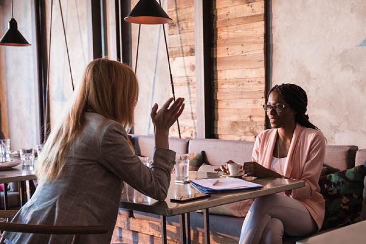 Female mentor/mentee meeting for coffee