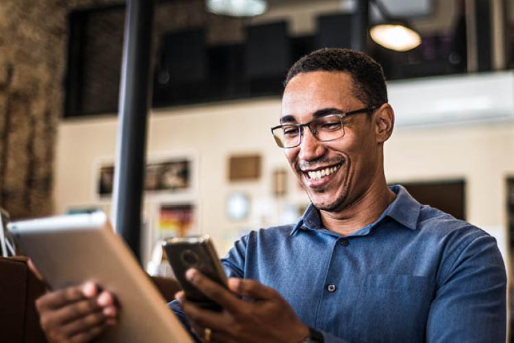 Working professional utilizing phone and table to check emails