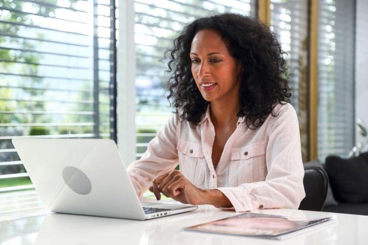 African American working professional working and learning on laptop computer