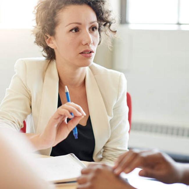 Female professional having candid conversations with team members