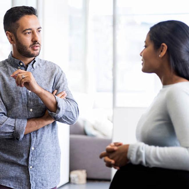 Male and female working having an intense conversation at work